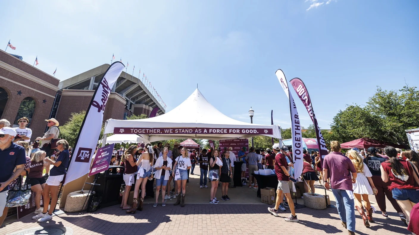 Aggies participating in the "Together, we stand as a force for good" pop-up activation before a football game