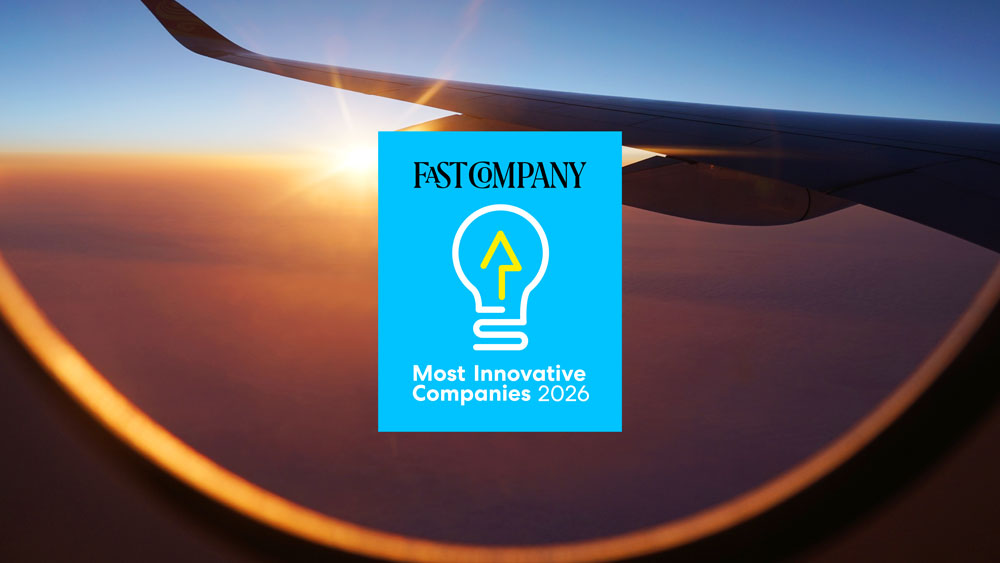 Fast Company Most Innovative Company logo over a plane wing in flight